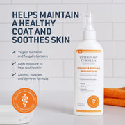 A bottle of Veterinary Formula Antiseptic & Antifungal Medicated Spray stands on a white surface against a white tiled wall. The bottle is white with orange accents and a white spray top.