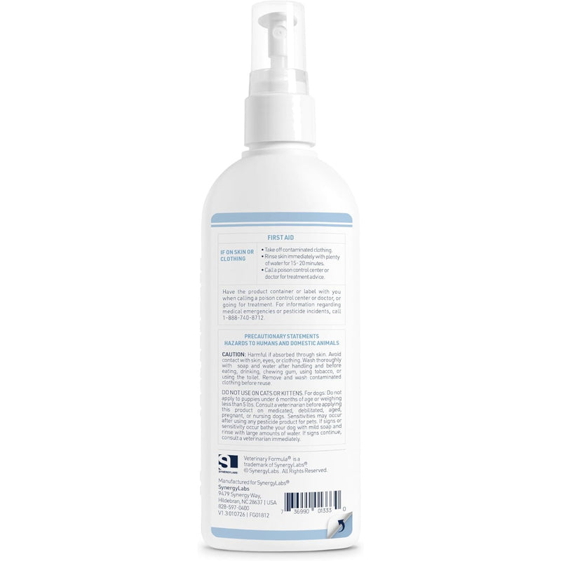 A white pump bottle of Veterinary Formula Flea & Tick Spray for dogs shown from the back, displaying detailed product instructions and warnings on a clean white background.
