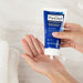Woman squirting PanOxyl Acne Foaming Wash Maximum Strength into her hands prior to washing.