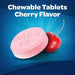 Gas X Cherry Creme tablet placed next to a cherry fruit