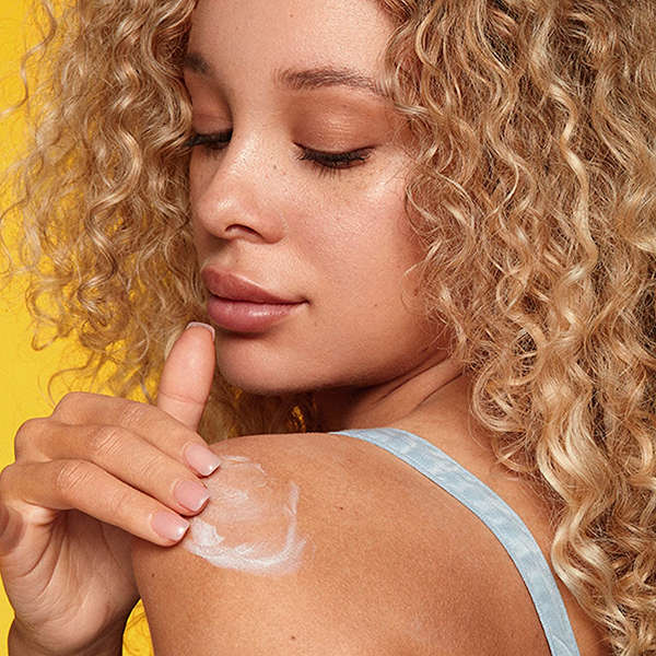 Neutrogena Beach Defense Sunscreen Lotion SPF 70 Banner showing a female applying sunscreen to her shoulder